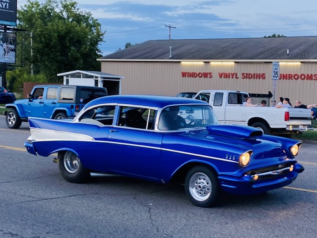 Classic blue vintage car parked on the street during daytime.