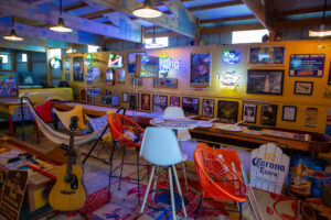 Colorful, cozy bar interior with eclectic seating and vibrant decor.