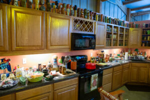 Cluttered kitchen counter with various cooking items and utensils.