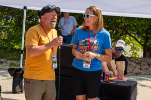 Two people engaging in lively conversation at an outdoor event.