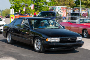 Classic black Chevrolet sedan parked outdoors on a sunny day.
