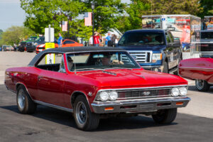 Classic red muscle car parked on a sunny day.