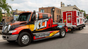 A colorful truck with KLIF radio station branding parked outdoors.