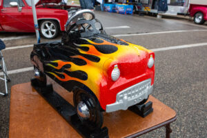 A toy car painted with red, yellow, and black flames.