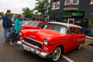 Classic red Chevrolet car displayed at an outdoor car show.