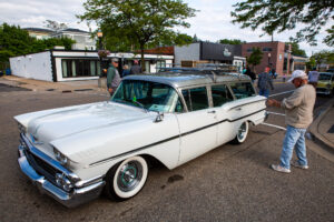 Classic white station wagon car parked on a city street.