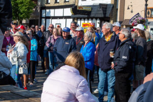 A group of people gathered outdoors on a sunny day.
