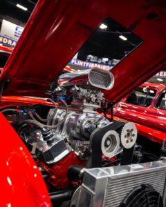 Powerful red car engine with chrome details on display.