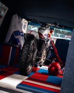 Racing motorcycle parked in a dimly lit garage area.