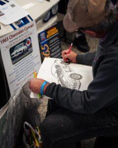 Artist sketching a detailed cartoon character on paper.