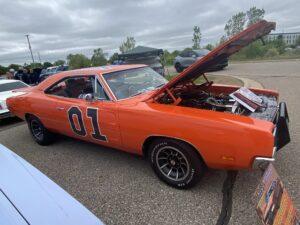 Orange classic muscle car with '01' on the door and hood open.