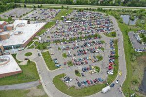 A large parking lot filled with numerous parked cars.