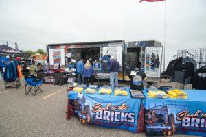 Outdoor vendor booth selling LEGO bricks and sets.