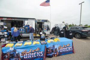 A merchandise booth selling 'Solar Bricks' apparel at an outdoor event.