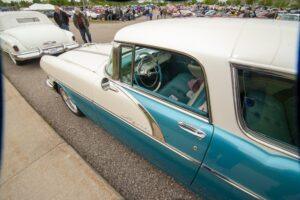 Classic turquoise and white vintage car parked on the street.
