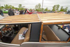 Vintage wooden convertible car with a sleek interior design.