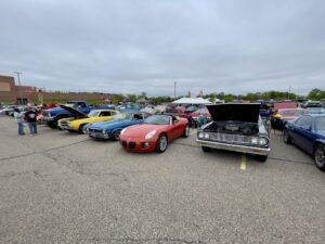 A lineup of classic cars parked on an overcast day.