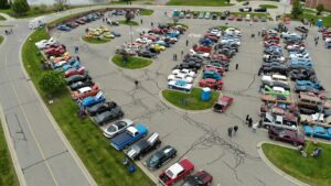 Aerial view of a busy parking lot with many cars and people walking.