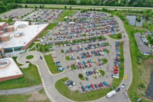 A large parking lot filled with cars next to a shopping center.