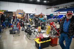 Busy workshop filled with various automotive parts and tools.