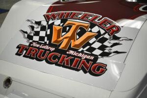 Vehicle decal for Wheeler Trucking in Michigan with checkered flags.