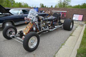 Custom trike motorcycle with a vintage design and large front wheel.