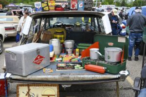 A trunk sale with various vintage tools and containers.