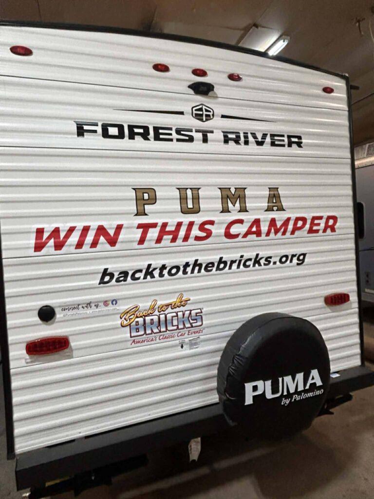 Camper with "Win This Camper" sign.