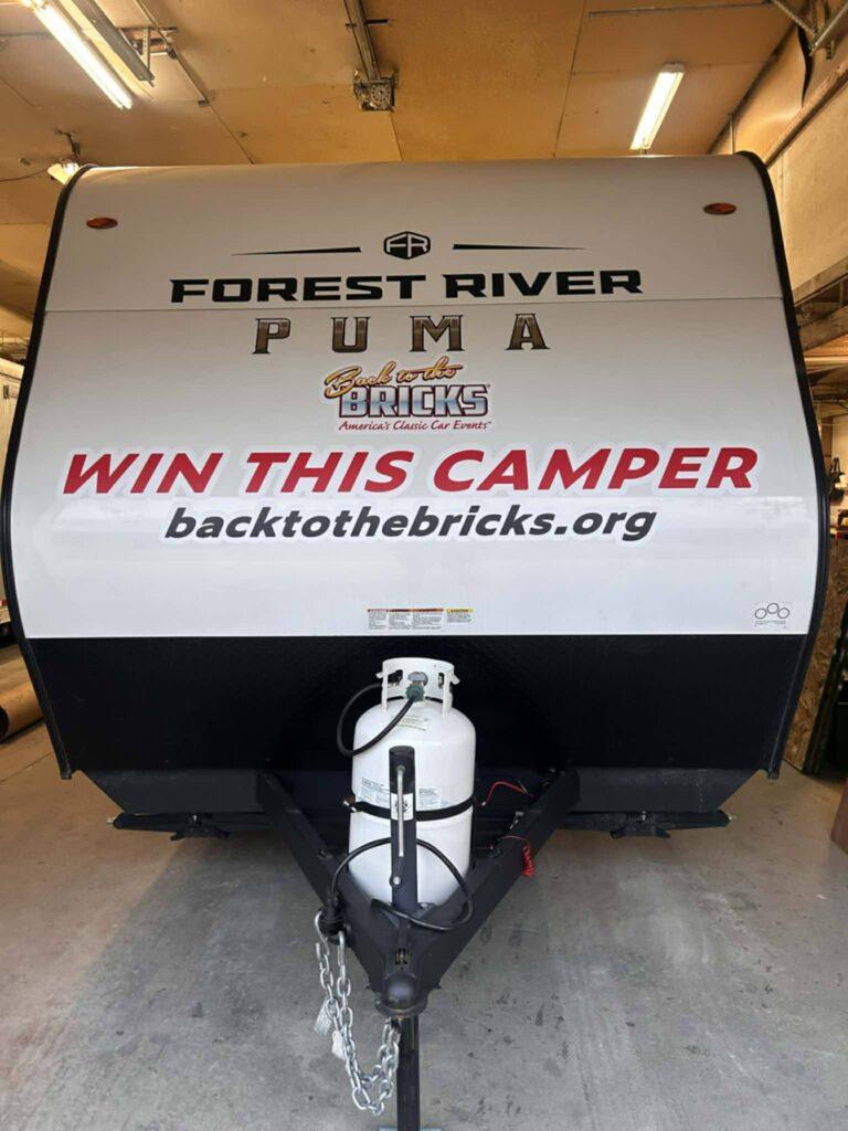 Camper trailer with promotional text displayed.