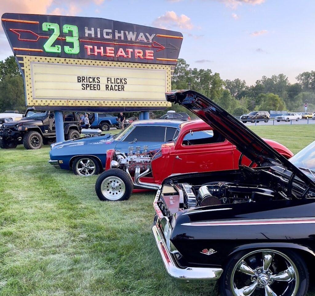 Classic cars displayed at outdoor drive-in theatre.