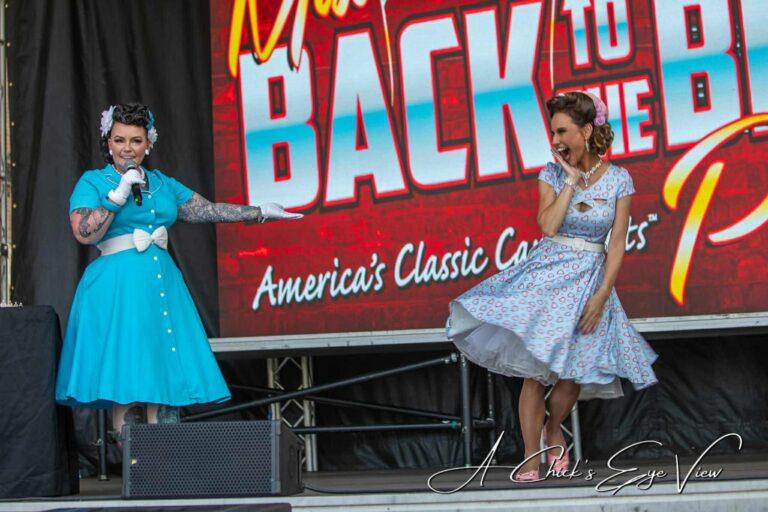 Women in vintage dresses on stage.