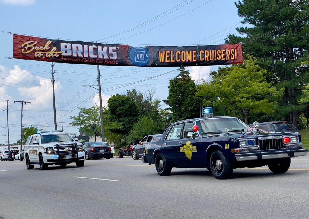 Police cars under "Back to the Bricks" banner.