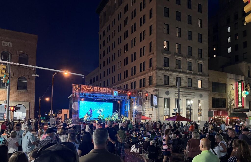 Outdoor concert in city street at night.