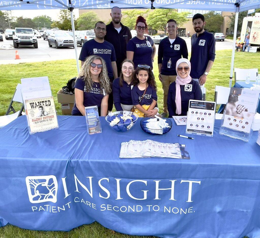 Group at Insight Health fair booth.