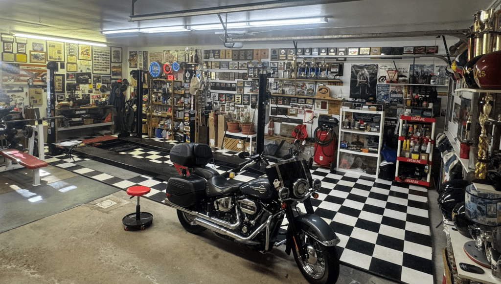 Motorcycle in garage with checkered floor.
