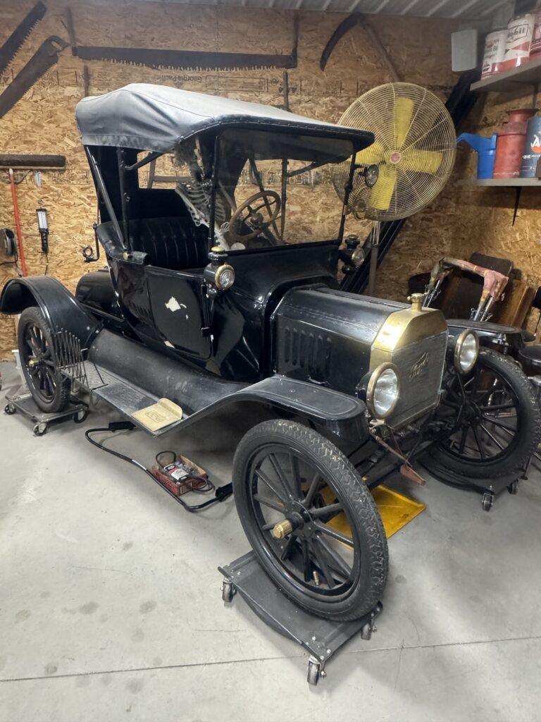 Vintage black car in a garage setting.