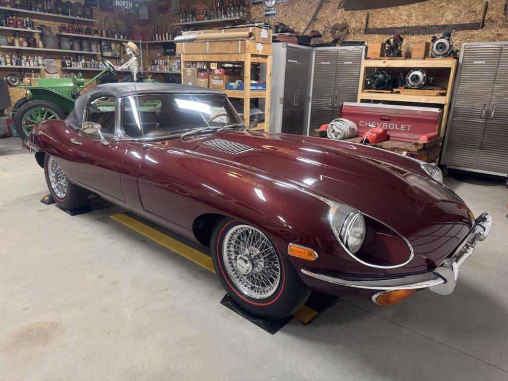 Classic maroon car in a garage setting.