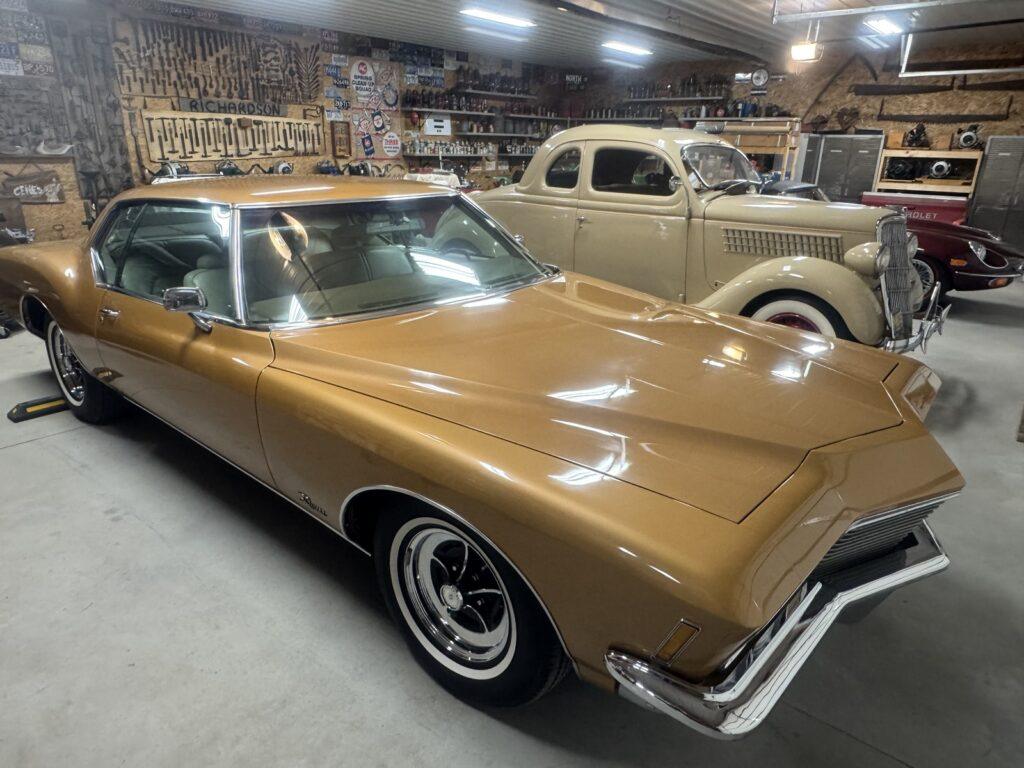 Vintage cars displayed in a garage.