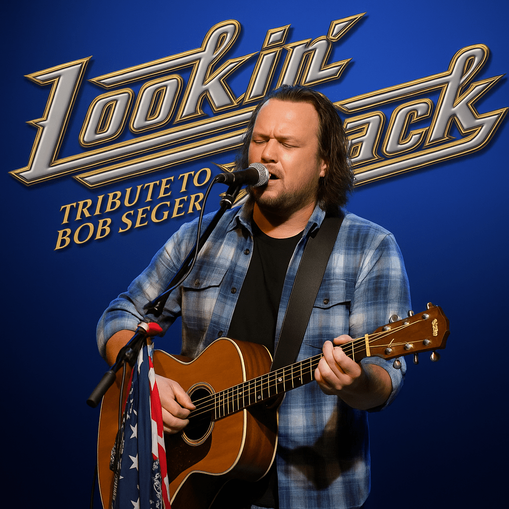 Musician performing with guitar on stage.