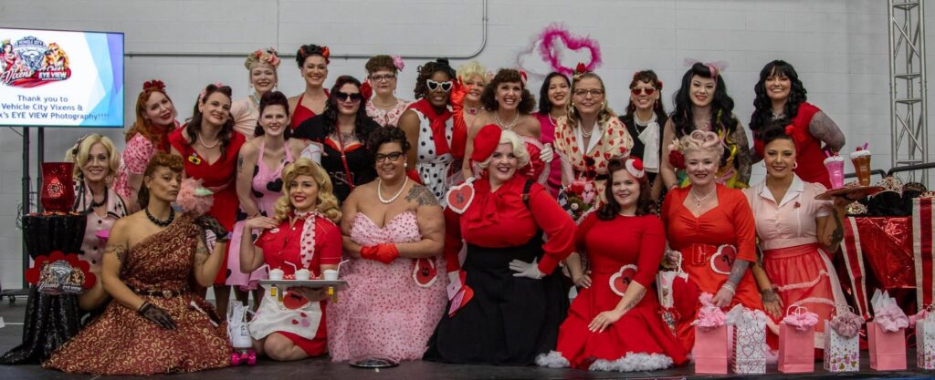 Group of women in retro outfits posing together.